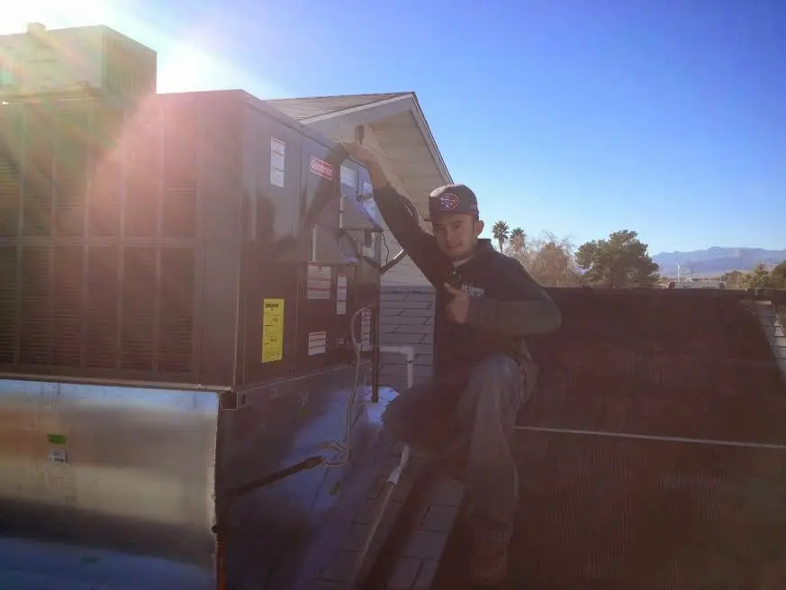 HVAC technician performing Air Duct Repair on a rooftop unit in Salida del Sol Estates